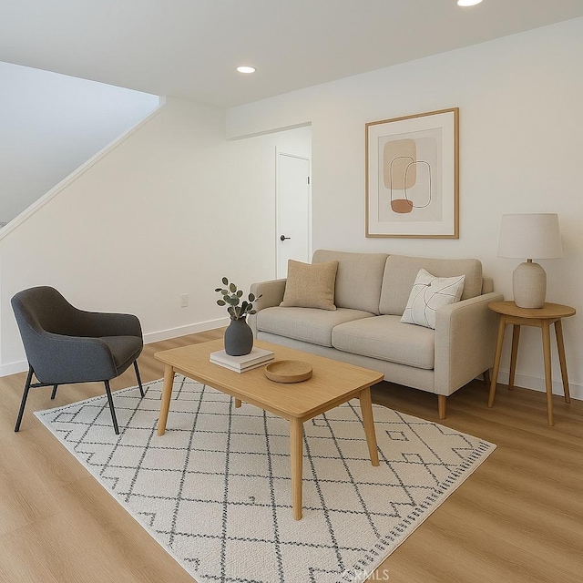 living area featuring light wood-style flooring, baseboards, and recessed lighting
