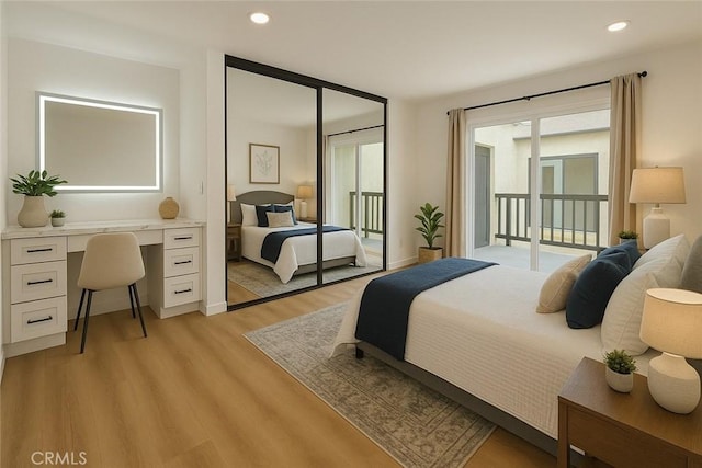 bedroom featuring access to exterior, light wood-type flooring, and recessed lighting