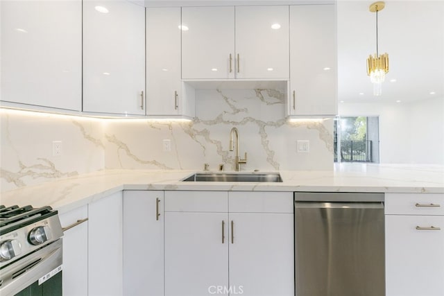 kitchen featuring appliances with stainless steel finishes, white cabinetry, and a sink