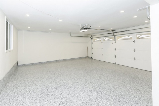 garage with recessed lighting and a garage door opener