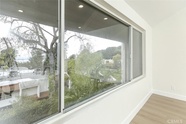 interior details featuring recessed lighting, wood finished floors, and baseboards