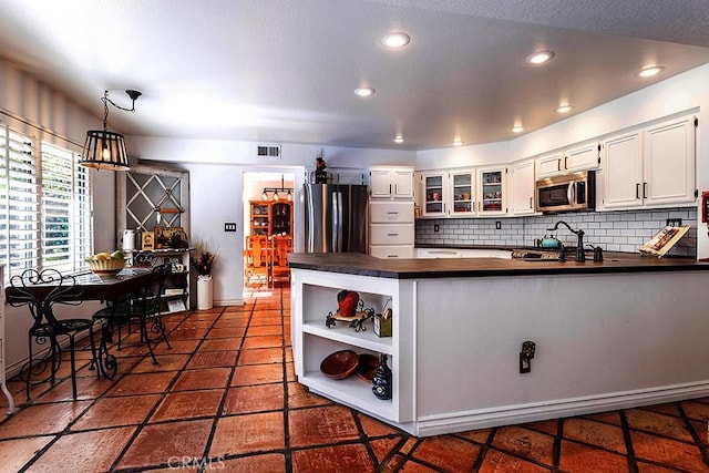 23461 Darcy Ln, Newhall, CA 91321 - kitchen featuring stainless steel microwave, freestanding refrigerator, a peninsula, tasteful backsplash, and recessed lighting