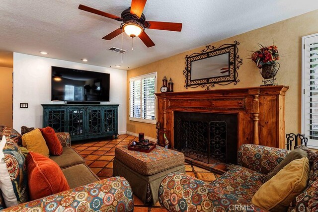 23461 Darcy Ln, Newhall, CA 91321 - tiled living area featuring a fireplace, ceiling fan, a textured ceiling, and baseboards