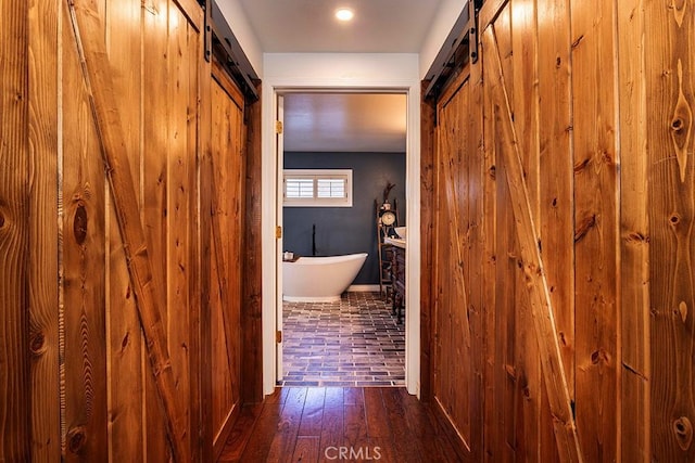 23461 Darcy Ln, Newhall, CA 91321 - hall with a barn door, baseboards, and hardwood / wood-style floors