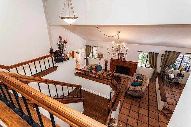 23461 Darcy Ln, Newhall, CA 91321 - stairs with a chandelier, a fireplace, and baseboards