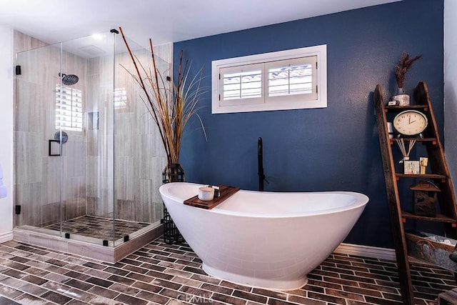 23461 Darcy Ln, Newhall, CA 91321 - bathroom featuring a shower stall, a freestanding bath, baseboards, and brick patterned flooring