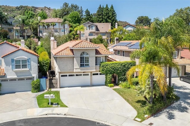 23461 Darcy Ln, Newhall, CA 91321 - mediterranean / spanish-style house featuring a residential view, concrete driveway, a garage, a tiled roof, and a chimney