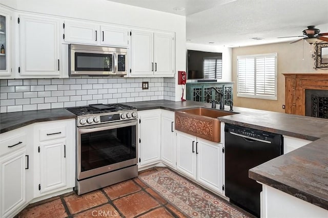 23461 Darcy Ln, Newhall, CA 91321 - kitchen featuring stainless steel appliances, dark countertops, a peninsula, tasteful backsplash, and white cabinets