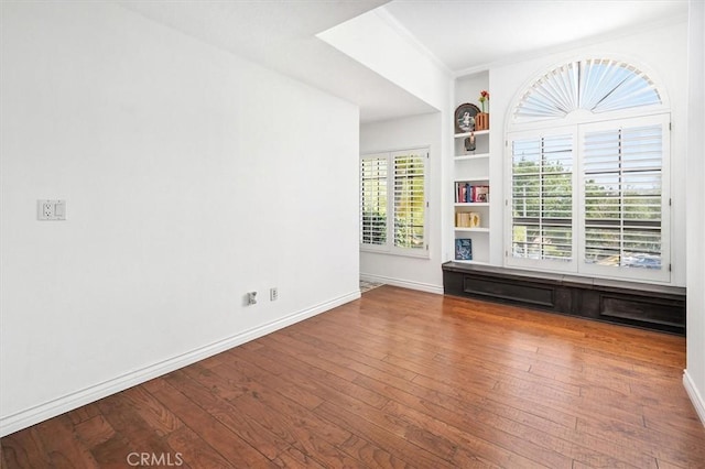 23461 Darcy Ln, Newhall, CA 91321 - unfurnished room with built in shelves, wood-type flooring, and crown molding