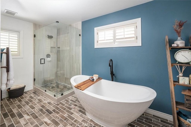 23461 Darcy Ln, Newhall, CA 91321 - bathroom with plenty of natural light, a soaking tub, a stall shower, and brick patterned flooring