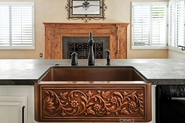 23461 Darcy Ln, Newhall, CA 91321 - kitchen view of ceiling fan, dark countertops, and dishwashing machine