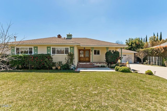 single story home with a front lawn, stucco siding, french doors, a chimney, and driveway