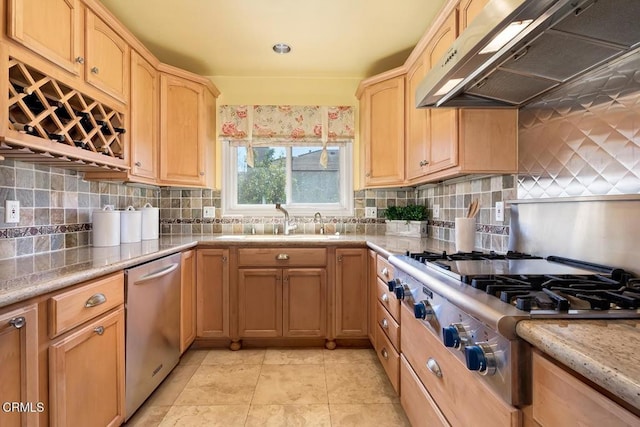 kitchen featuring light brown cabinets, a sink, backsplash, appliances with stainless steel finishes, and exhaust hood