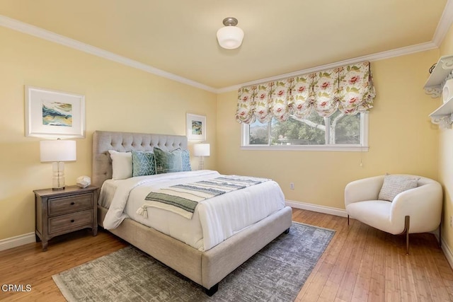 bedroom with baseboards, wood finished floors, and crown molding