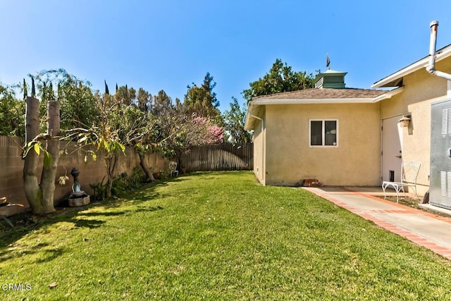 view of yard featuring a patio and a fenced backyard