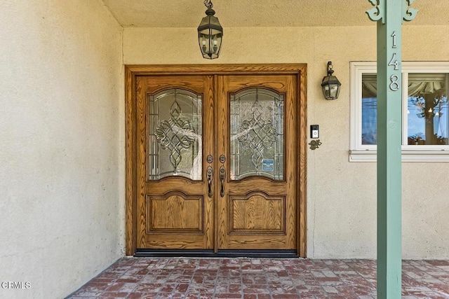 entrance to property featuring stucco siding