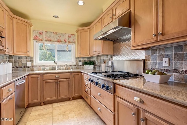 kitchen with backsplash, under cabinet range hood, light tile patterned floors, stainless steel appliances, and a sink