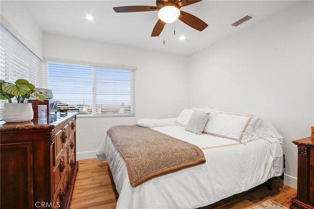 bedroom featuring visible vents, baseboards, ceiling fan, light wood-type flooring, and recessed lighting