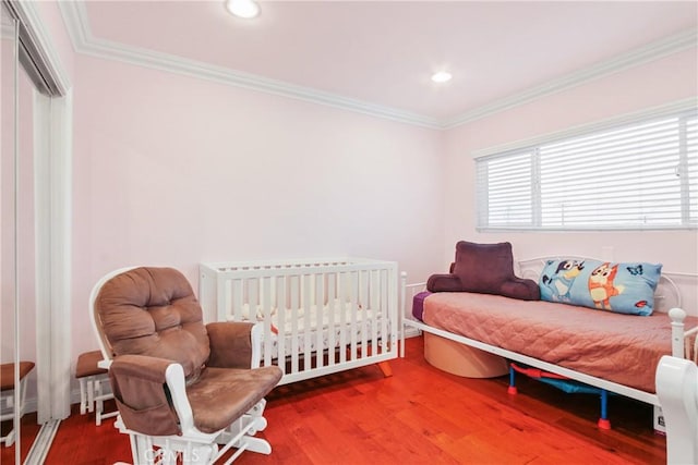 bedroom featuring recessed lighting, crown molding, and wood finished floors