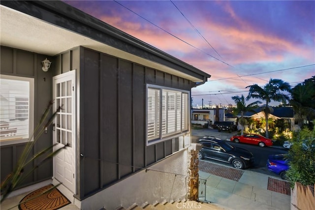 property exterior at dusk with board and batten siding