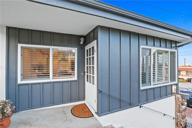 doorway to property featuring board and batten siding