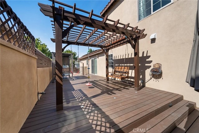 wooden terrace featuring a pergola and fence