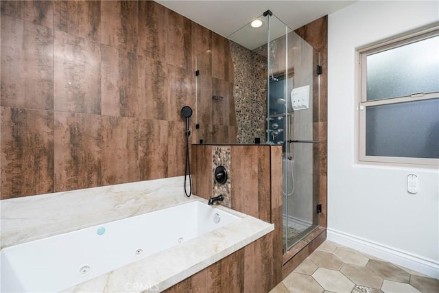 bathroom featuring a tile shower, a tub with jets, tile patterned floors, and baseboards