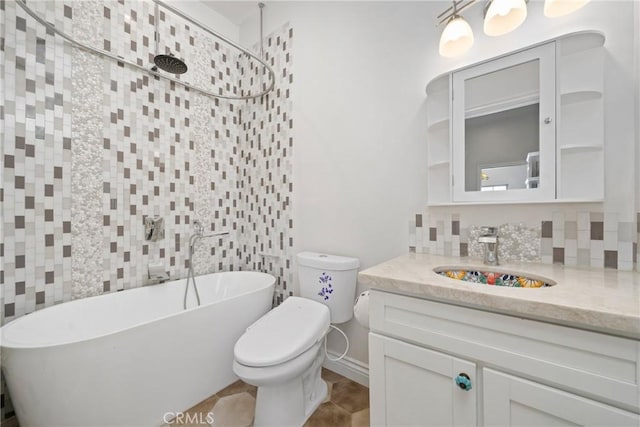 bathroom with vanity, a freestanding tub, a tile shower, toilet, and tasteful backsplash