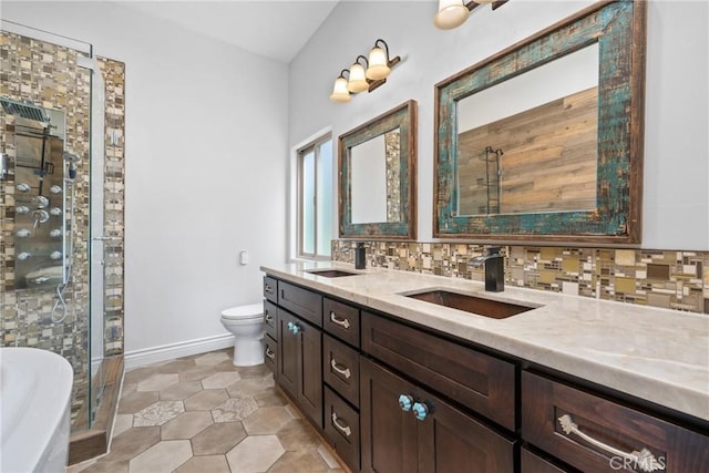 bathroom featuring a sink, backsplash, a stall shower, and toilet