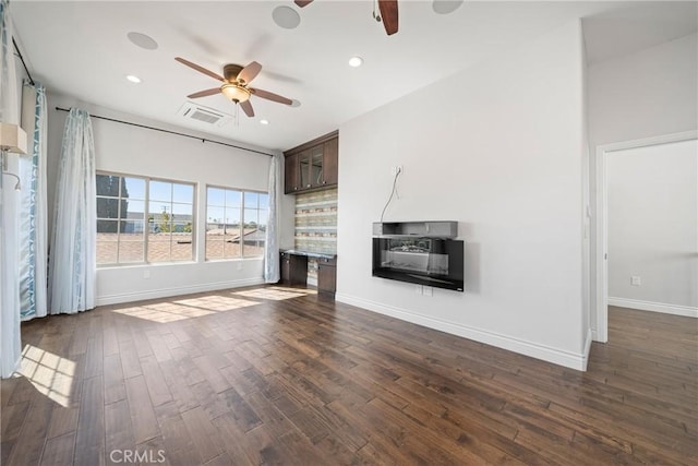 unfurnished living room with visible vents, dark wood-type flooring, a ceiling fan, recessed lighting, and baseboards