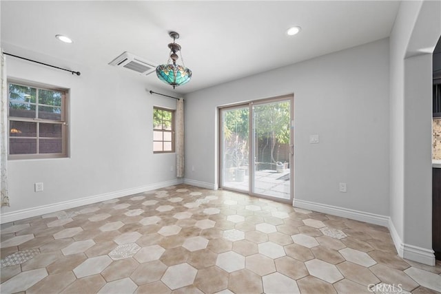 unfurnished room with recessed lighting, visible vents, and baseboards