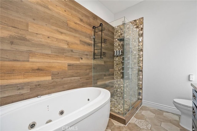 bathroom featuring toilet, a jetted tub, a shower stall, tile patterned flooring, and baseboards