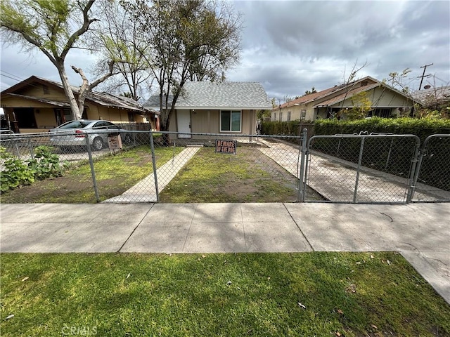 view of front of house featuring a fenced front yard, a front yard, and a gate