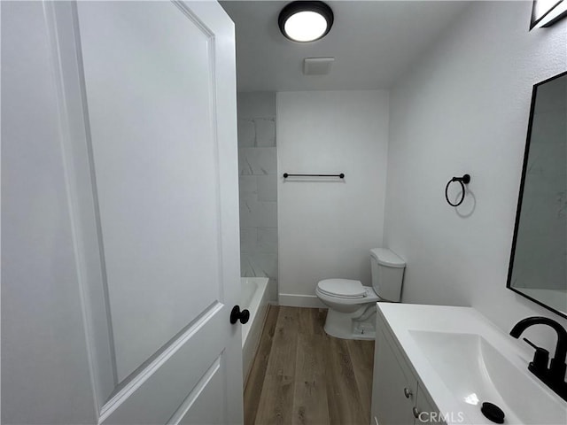 bathroom with vanity, toilet, and wood finished floors