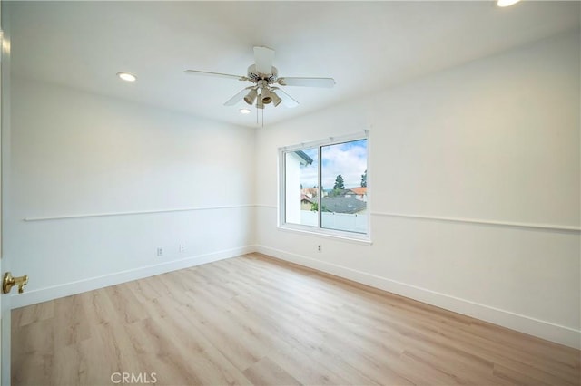 spare room with recessed lighting, a ceiling fan, baseboards, and wood finished floors