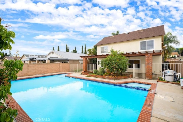 view of pool featuring a patio area, a fenced backyard, a pergola, and a pool with connected hot tub