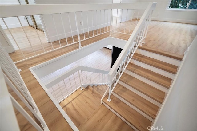 stairway featuring wood finished floors