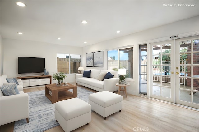 living area with recessed lighting, light wood-type flooring, and french doors