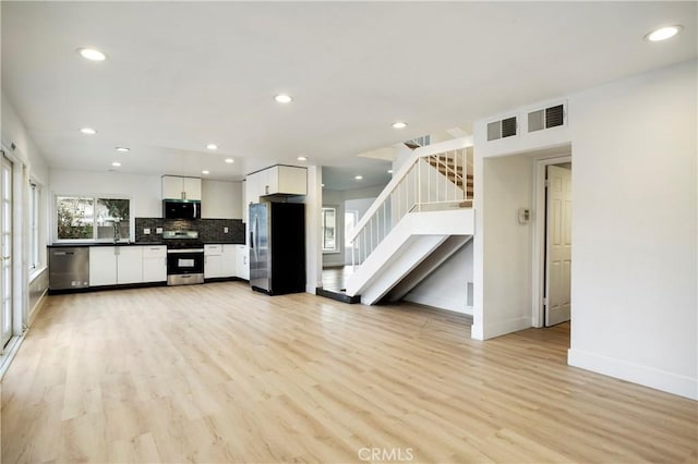 interior space featuring recessed lighting, visible vents, and light wood-style floors