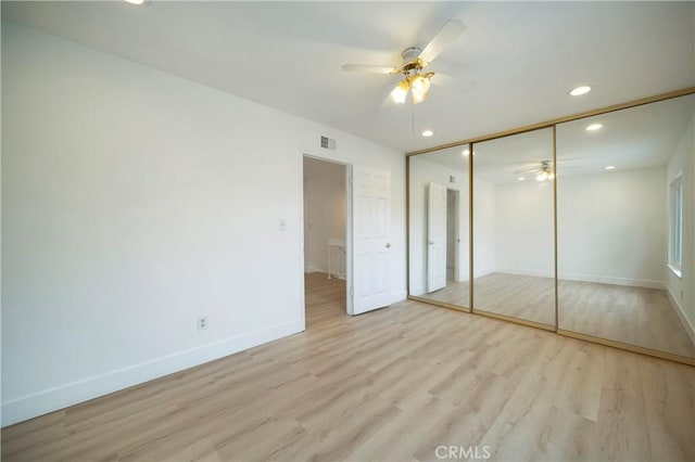 unfurnished bedroom featuring visible vents, recessed lighting, a closet, light wood-style floors, and baseboards