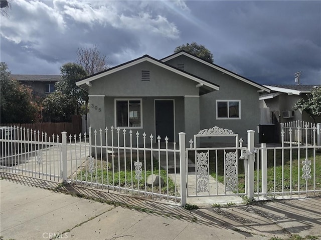 view of front of property with a fenced front yard and stucco siding