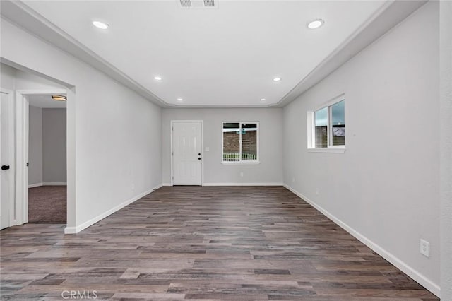 empty room featuring baseboards, visible vents, wood finished floors, and recessed lighting