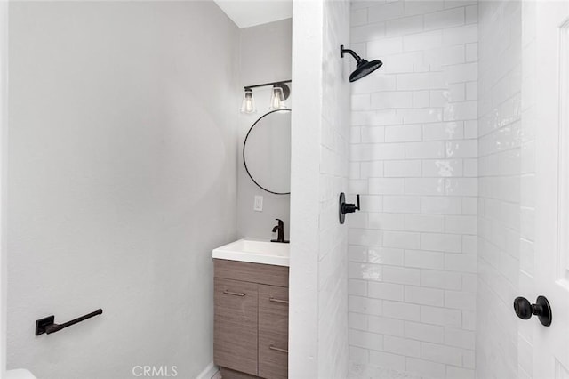 full bathroom with vanity and tiled shower