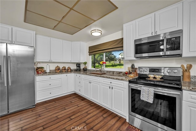 kitchen featuring white cabinetry, stainless steel appliances, and a sink