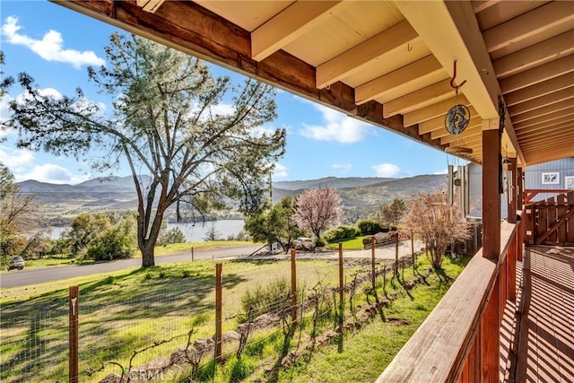 exterior space featuring a mountain view and fence