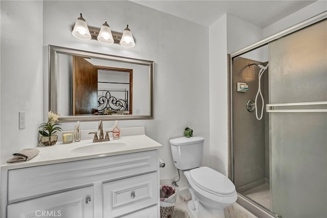 bathroom featuring vanity, toilet, and a stall shower