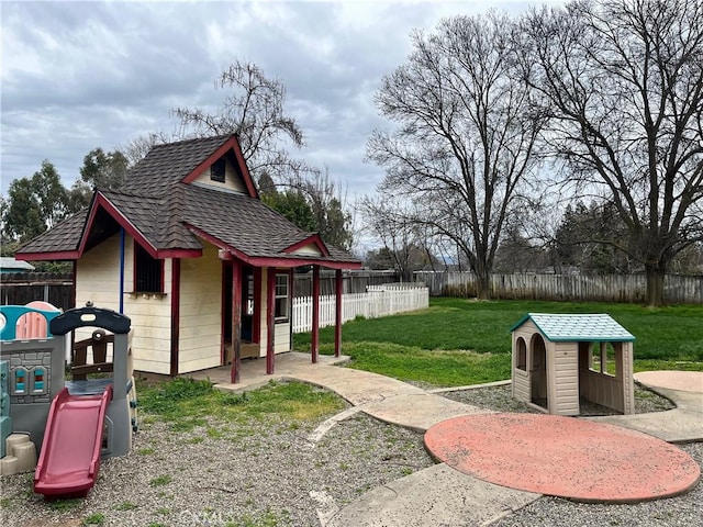 view of yard with a fenced backyard and playground community