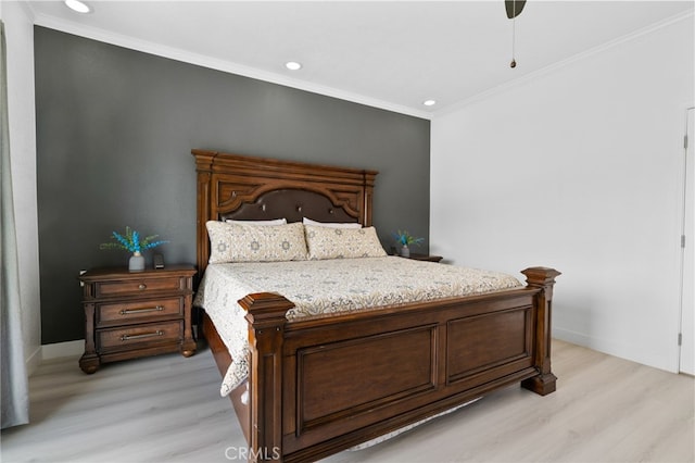 bedroom featuring light wood-type flooring, baseboards, and crown molding