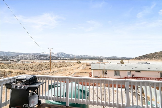 wooden terrace featuring a mountain view and area for grilling