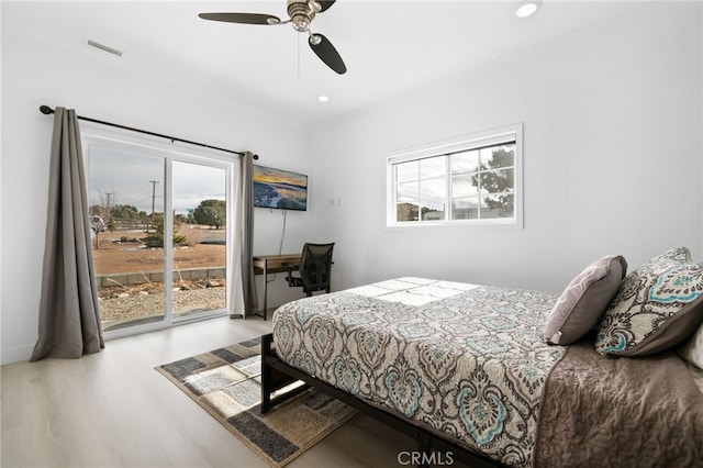 bedroom with a ceiling fan, wood finished floors, visible vents, recessed lighting, and access to exterior